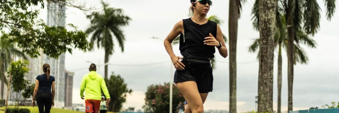 Woman jogging in a tropical park in Panama City on an overcast day.